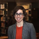 Headshot of Caitlin in a library